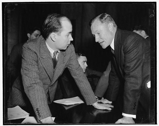 A sharp questioner. Washington, D.C., Dec. 15. Hugh L. Cox, who as Special Assistant to the Attorney General is acting as one of the counsel for Joint Monopoly Committee, is proving a shrewd questioner at the daily hearings. Cox, left, is pictured quizzing J.H. McNash of Hazel-Atlas Glass Container 