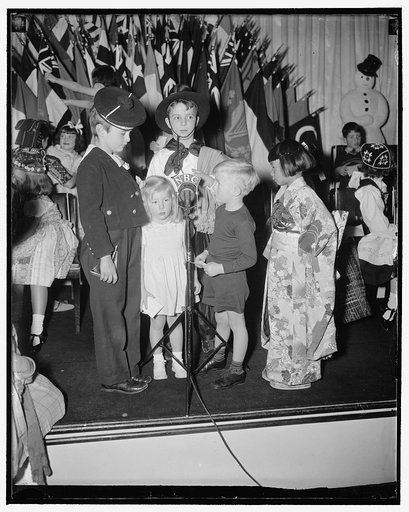 Diplomatic children broadcast Xmas greeting. Washington, D.C., Dec. 20. Christmas greetings in all tongues were broadcast all over the world today by the tiny sons and daughters of foreign diplomats participating in Annual International Children's Christmas Program staged by the National Broadcastin