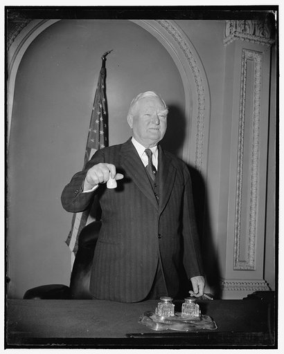 Vice President ready for opening. Washington, D.C., Dec. 29. A sure sign that Congress is ready to convene on January 3. Vice President Garner posing, gavel in hand, on the rostrum in the Senate chamber, 12/29/38