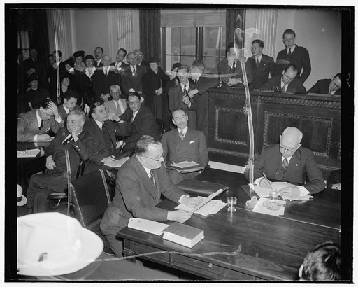 Frankfurter Counsel listens to testimony opposing appointment of Harvard professor. Washington, D.C., Jan. 10. Dean Acheson, right, former Undersecretary of the Treasury, as counsel for Prof. Felix Frankfurter, listens to testimony opposing his client's appointment to the Supreme Court before the Se