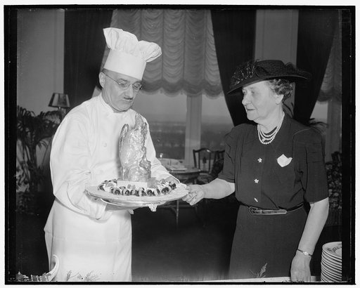 Issues final orders to chef. Washington, D.C., Jan. 10. Mrs. John N. Garner, wife of the Vice President, who for the first time this year entertained the members of the Senate Ladies Luncheon Club, issues final orders to the Chef J.E. Cheganeo, just before the guests begin to arrive, 1/10/39