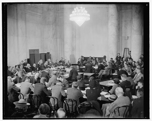 Hopkins takes stand before Senate Commerce Committee. Washington, D.C., Jan. 11. Scene at the Senate Commerce Committee hearing room today as Harry Hopkins--shown in center--took the stand to answer questions concerning his fitness for the post of Secretary of Commerce to which he was recently appoi