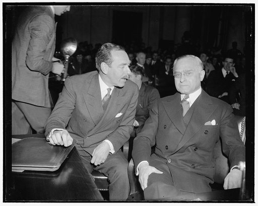 Whispered advice from counsel. Washington, D.C., Jan. 12. Prof. Felix Frankfurter, Supreme Court Nominee, gets a bit of whispered advice from his counsel Dean Acheson, left, just before taking the stand today before the Senate Judiciary Subcommittee to answer questions as to his fitness for the High
