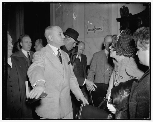 Grants critic of Frankfurter copy of testimony before Senate committee. Washington, D.C., Jan. 12 . Chairman M.M. Neely of the Senate Judiciary Subcommittee pictured as he told Mrs. Elizabeth Dilling that she was welcome to a copy of Frankfurter's testimony. 'Take it. Any part of all of', he exclaim