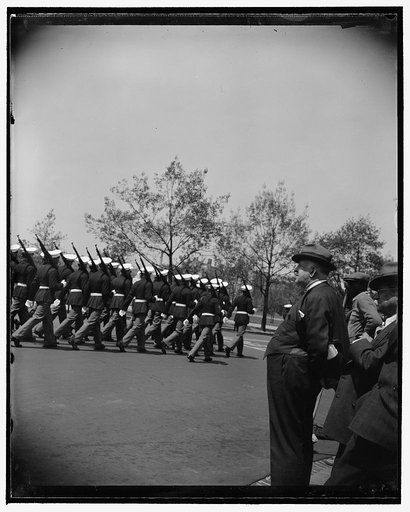 Massachusetts Senator 'loves a parade.' Washington, D.C., May 12. Whenever a military or naval parade passes the Capitol, Senator David I. Walsh, Chairman of the Senate Naval Affairs Committee, can always be found viewing it. He is shown viewing the troops which took part in the recent welcome to Pr