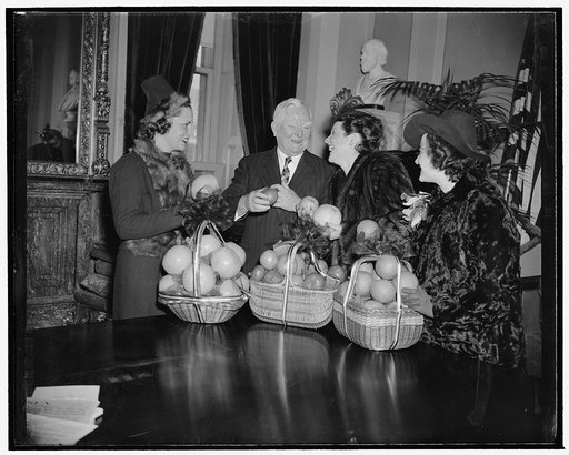 Beauties present Vice President Garner with baskets of fruit to inaugurate Citrus Week. Washington, D.C., Jan. 23. National Citrus Week got off to a good start today when beauties from the citrus-growing sates presented Vice President Garner with baskets of the luscious fruit. Left to right: Martha 