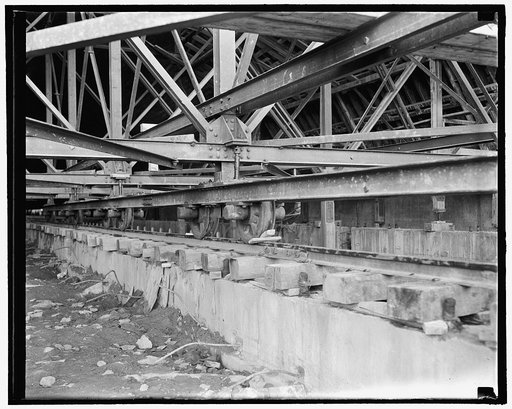 While construction is underway, the uncompleted sections of the roof must be mobile in order that a perfect fit may be made. Steel rails are laid and the sections of roof mounted upon them, allowing the giant pieces to be moved by a small crew with block and tackle