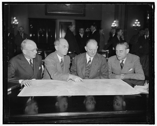 Admirals at House get together. Washington, D.C., Jan. 25. Rear Admiral A.J. Hepburn, Admiral William D. Leahy, Chief of Naval Operations, Rep. Carl Vinson, Chairman of the House Naval Affairs Committee, and Rear Admiral Arthur B. Cook, all poring over maps of the Pacific Ocean at the hearings over 