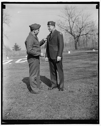 CCC steps out in new uniform. Washington, D.C., Feb. 1. Members of the Civilian Conservation Corps today stepped out in a new uniform of spruce green. The new uniform worn by Frank Papuga, right, is quite a contrast from the old one of olive drab pictured on Robert Alesandri. A two-button sack coat,