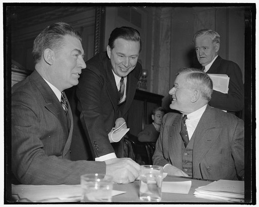 Amlie with committeemen investigating him. Washington, D.C., Feb. 6. With apparently no resentment toward committee members who are questioning his fitness for membership in the ICC, former Rep. Thomas R. Amlie posed with them. Left to right: Senator Edwin C. Johnson, Chairman, Amlie, Senator Clyde 