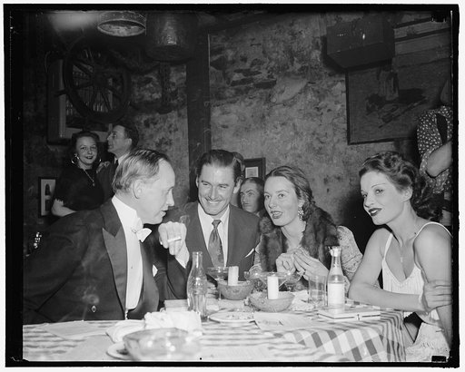 Hopkins and Stars see club opening. Washington, D.C., Feb. 8. Washington's newest supper club opened last night with celebrities and stars in attendance. Here, Hopkins, Secretary of Commerce, movie star Errol Flynn and Mrs. John Hay Whitney, wealthy socialite, found their way to fun. Note the 'pop' 