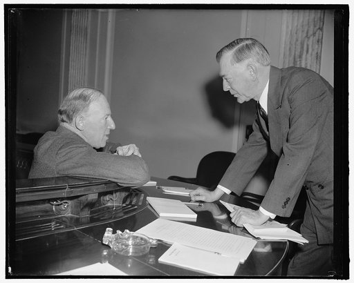 In huddle. Washington, D.C., Feb. 21. Assistant Secretary of State Francis B. Sayre, left, in a huddle with Senator Key Pittman following Sayre's Appearance before the Senate Territorial and Insular Affairs Committee today in support of amendments to the Tydings-McDuffie Independence Act. Sayre told