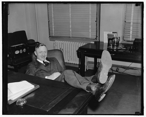 New Supreme Court Nominee. Washington, D.C., March 20. William O. Douglas, at 40 youngest man ever to be appointed to the Supreme Court, was all smiles and perfectly relaxed as cameramen called on him following the announcement by president Roosevelt today. Lounging back with feet on desk this pictu