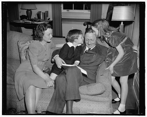 Newest Supreme Court appointee and family. Washington, D.C., March 20. Mrs. William Douglas, William, Jr., William Sr., and daughter Mildred Riddle at home tonight as they posed for photographs, following a day of excitement at the SEC when the President announced Mr. Douglas as his newest appointee