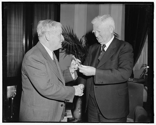Vice President congratulates Senate press gallery head on 30 years of service. Washington, D.C., March 22. Rounding out 30 years of service in the Senate Press Gallery today, William J. Collins, present Superintendent, is congratulated by Vice President Garner and accepts one of the V.P.'s favorite 