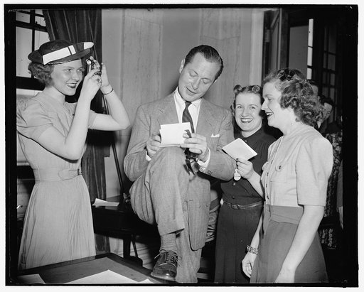 Screen idol besieged by autograph hunters in Capitol appearance. Washington, D.C., April 3. Arriving early at the Capitol today for an appearance before the Senate Interstate Commerce Committee, screen actor Robert was kept busy autographing until called to the stand. Here we see, left to right - Fr