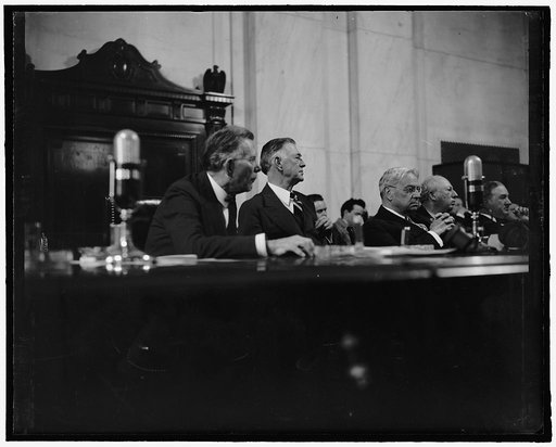 Attentative experts. Washington, D.C., April 6. All experts on foreign relations, these three Senators - William E. Borah, left, Key Pittman, and Hiram Johnson - listen attentively as Barnard Baruch testifies before Senate Foreign Relations Committee. Senator Pittman is present Chairman of the Commi