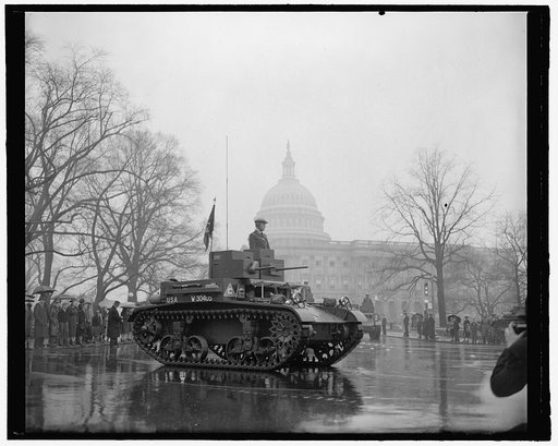 Latest types of tanks rumble past The Capitol in Annual Army Day Parade. Washington, D.C., April 6. Memories of the World War were revived today as the latest types of tanks, preceded by 20,00 soldiers and veterans, paraded past the U.S. Capitol in the Annual Army Day Parade which marked the 22nd an