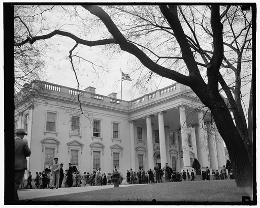 White House mecca for Easter holiday sightseers. Washington, D.C., April 11. Easter Holidays bring thousands of visitors to the Capitol every year. Naturally, the first stop for the sightseers is the White House as this picture indicates. 4-11-39