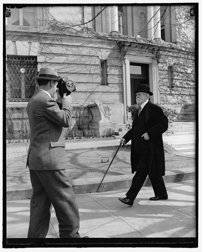 Chief Justice takes brisk walk on 77th birthday. Washington, D.C., April 11. Celebrating his 77th birthday today, Chief Justice Charles Evans Hughes of the United States Supreme Court, is snapped by a news cameraman as he takes his usual morning stroll. The Chief Justice appears fully recovered from