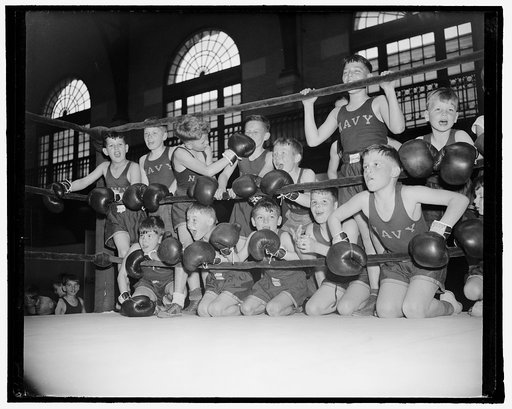 Cheering on the sidelines. Annapolis, MD, April 16. The Naval Academy here held its 20th Annual Navy Junior Boxing Championships with all the formality bestowed upon big college bouts, but the fighters were all pre-high school size, ranging from 3 to 14 years. Gene Fairfax, Captain of the Academy bo