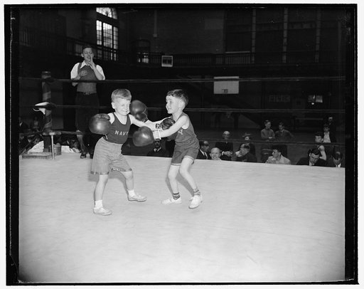 A couple of champs mixing up. Annapolis, Md., April 15. The Navy Junior Boxing Championships for sons of Naval Officers stationed at the Naval Academy here got underway today with much action and little in the way of bloodshed. This 20th annual tournament was entered by more than 100 lads ranging fr