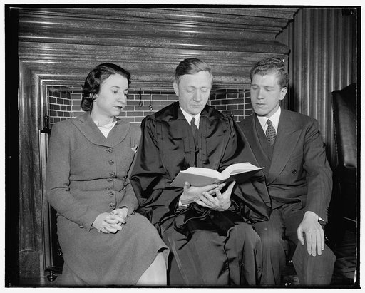 Douglas confers with Secretary and law clerk. Washington, D.C., April 17. When a new justice of the Supreme Court takes his place on the bench, a law clerk and secretary are assigned to him. Here, left to right are: Edith Waters, secretary, Justice Douglas, and law clerk David Ginsberg