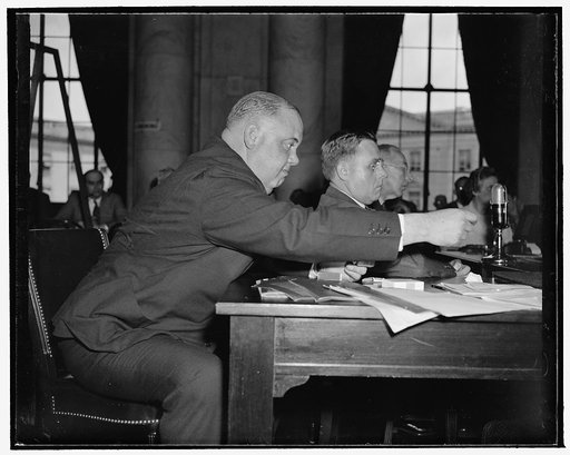 Brass industrialist tells Monopoly Committee they 'follow the leader and pray for profit.' Washington, D.C., May 9. H.L.Randall, President of the Riverside Metal Co., left, and John Coe, Jr., Vice President of the American Brass Co., on the right, witnesses before the Monopoly Committee's hearings o