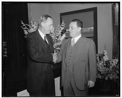 Leon Henderson shortly after being sworn in as member of Securities & Exchange Commission. Being congratulated by Harry Hopkins, Secy. of Commerce