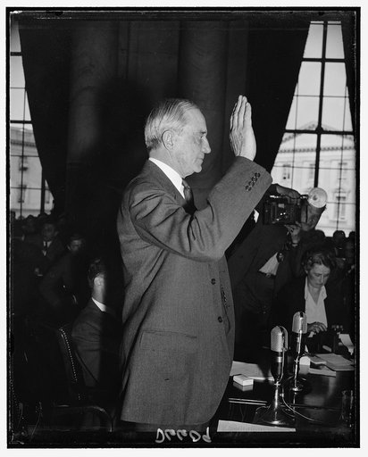 Owen D. Young, Chairman of the Board, General Electric, takes oath before testifying before Monopoly Investigating Committee