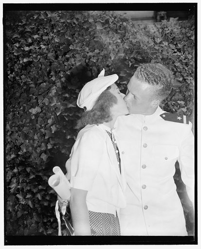 To the victor belong the spoils. Annapolis, Md. June 1. Walter B. Miller, who today was commissioned as an ensign at graduation exercises at the U.S. Naval Academy receives a welcome kiss of congratulation from his girlfriend, Betty Varina Crews. Both are from Columbia, S.C.