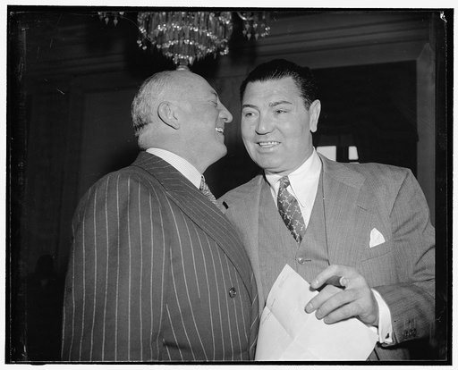Maybe they discuss Joe Lewis? Washington, D.C., May 25. Col. John R. Kilpatrick, President of the Madison Square Garden Corp., and Jack Dempsey having a whispered conversation before the beginning of today's hearing upon a bill by Sen. W. Warren Barbour to lift the ban upon the shipment of fight fil