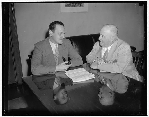 At Commerce Department conference. Left to right: Dr. Willard Thorpe, Economic Advisor to Secretary of Commerce Harry Hopkins, and Edward Kuykendall, Motion Picture Theater Owners of America