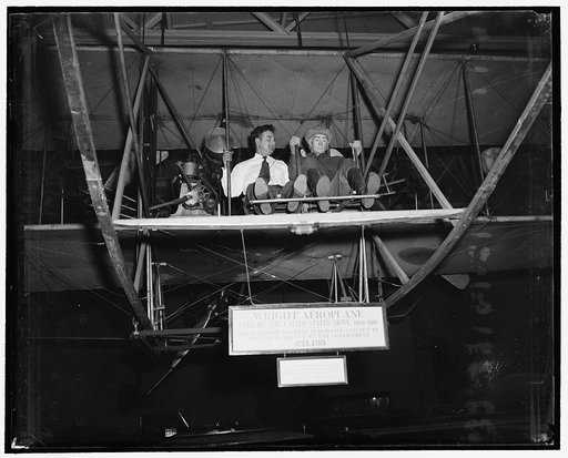 Dummy Oscar ready for Army Air Corps anniversary. Washington, D.C., June 30. Dummy Oscar, jauntily attired in the now antiquated army aviator's uniform of the first decade of the 20th century, sits clasping the sticks of the army's first airplane in readiness for the 30th anniversary of the birth of