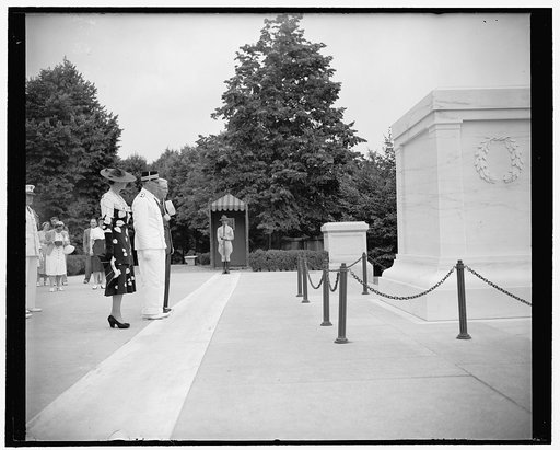 Norwegian royal couple pay tribute to America's Unknown Soldier. Washington, D.C., June 30. Crown Prince Olav and Princess Martha stand in silent tribute to America's Unknown Soldier as they visited Arlington National Cemetery today