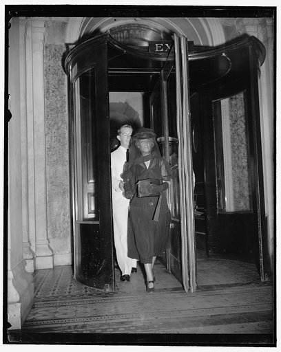 Swanson's widow arrives at Capitol for state funeral in Senate Chamber. Washington, D.C., July 10. Mrs. Claude A. Swanson, widow of the Navy Secretary, as she arrived at the Capitol accompanied by her son, Douglas Hall, where she attended the state funeral in the Senate Chambers for Secretary Swanso