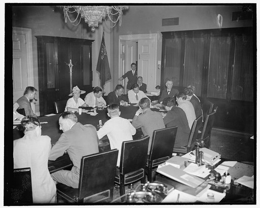 Popular press conference. Washington, D.C., July 14. Most popular of the press conferences at the Capitol these days are the ones held by Senator Key Pittman, Chairman of the Senate Foreign Relations Committee. Senator Pittman can be seen at the head of the table