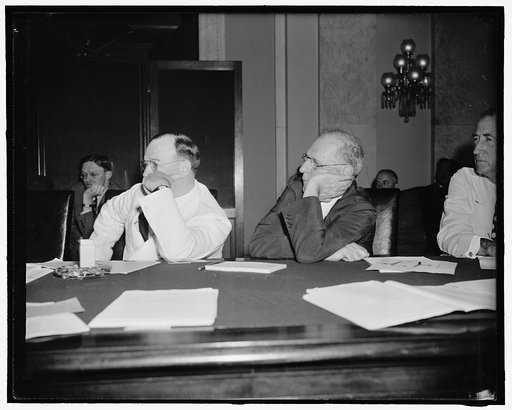 Interested listeners. Washington, D.C., July 19. Senators Francis T. Maloney, Left, Connecticut, and George L. Radcliffe, Maryland, lend an attentive ear to the testimony of Marriner Eccles, Chairman of the Federal Reserve Board, before the Senate Banking and Currency Committee today. Eccles told th