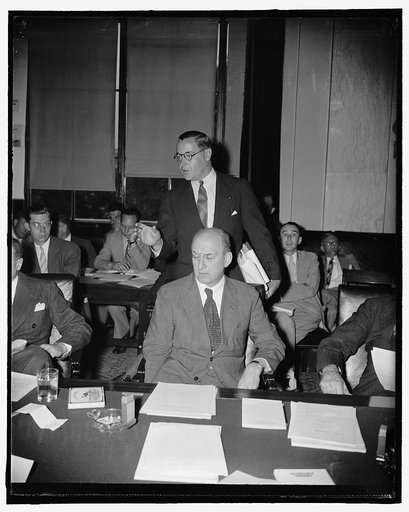 Secretary of Treasury Morgenthau lauds administration's new lending bill before senate committee. Washington, D.C., July 18. Secretary of Treasury Henry Morgenthau, seated, listens attentively while Edward H. Foley, treasury General Counsel, answers a question by the Senate Banking and Currency conc