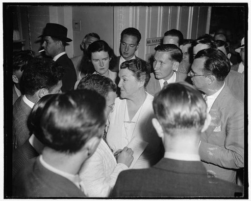 Reporters question Rep. Mary Norton. Washington, D.C., July 22. Reporters besiege Rep. Mary T. Norton, Democrat of New Jersey, following her appearance today before the House Rules Committee in executive session. The purpose of the hearing was determine whether the highly controversial amendments of