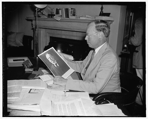 Sen. Robert A. Taft, who just tossed his hat into the ring for 1940 Republican nomination. Here viewing picture of his father, Wm. Howard Taft, who some 30 yrs before was seeking the republican nomination. Aug. 1939