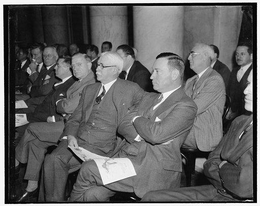 Attentive listeners. Washington, D.C., Nov. 1. Nathan L. Miller, General Counsel for U.S. Steel Corp., and Benjamin F. Fairless, President of the U.S. Steel Corp., listen attentively as the first witness testified when the National Monopoly Committee began its study today of the $4,000,000,000 steel