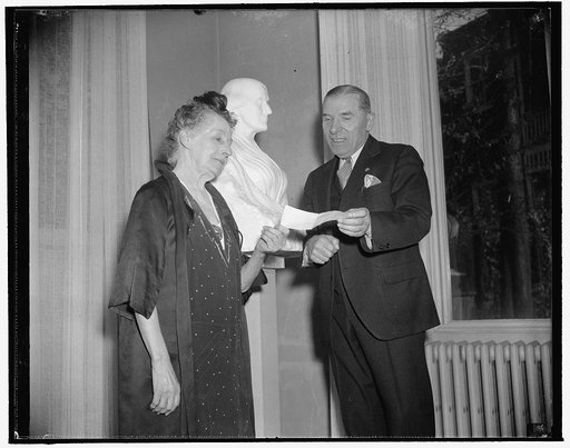 Rep. Bloom presents sculptress with check from anonymous New Yorker to save home. Washington, D.C., Nov. 18. Early this week a reporter on a local paper discovered that Adelaide Johnson, sculptress, who created the Susan B. Anthony Sufferagist Group in the U.S. Capitol, was about to be evicted from 