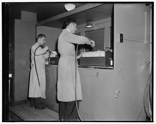 National Archives. Washington, D.C., Nov. 22. After leaving the gas chamber the documents are worked on by air blowers to eliminate all dust and foreign particles. The dust from the papers is carried out through the screen in the background into a purifier