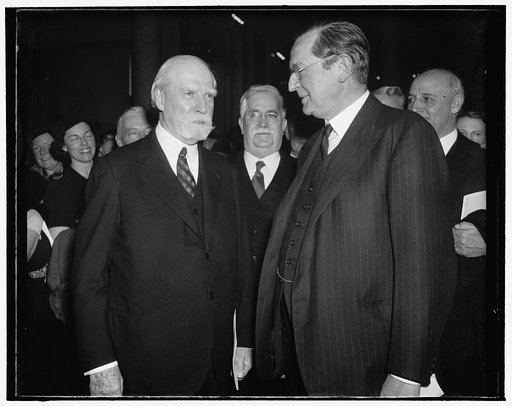 Chief Justice chats with British Ambassador as Magna Carta is placed in Library. Washington, D.C., Nov. 28. Among the notables to witness the deposit of the Magna Carta in the Congressional Library today was Chief Justice Charles Evans Hughes who is shown in this picture with British Ambassador Lord