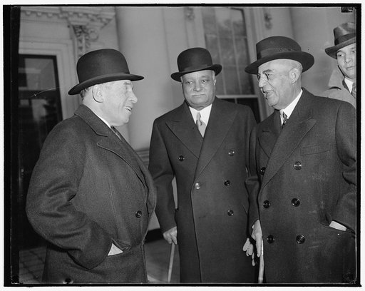 President of Haiti a luncheon guest of President Roosevelt. Washington, D.C., Dec. 11. President Roosevelt entertained at luncheon today in honor of President Stenio Vincent of Haiti, who is shown leaving the White House with Rep. Sol Bloom, left, Acting Chairman of the House Foreign Affairs Committ