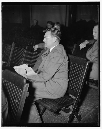 Former CIO union head listens to testimony before Labor hearings. Washington, D.C., Dec. 13. Homer Martin, President of the United Automobile Workers of America, AF of L faction, photographed this morning as he listened to testimony of Joe Ozanic. Martin was formerly Head of the CIO faction of the A