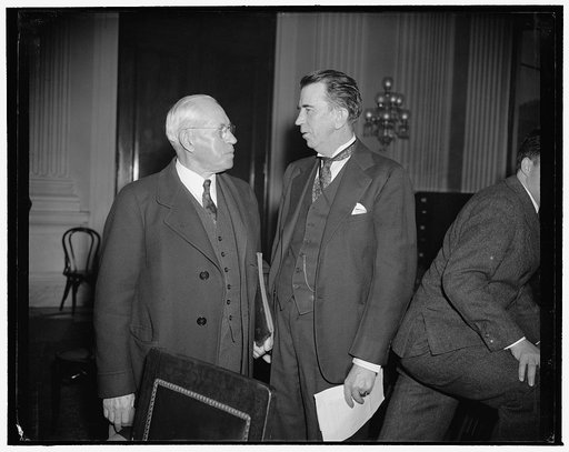 In spotlight at NLRB investigation. Washington, D.C., Dec. 14. John P. Frey, left, President of the Metal Trades Union, A.F. of L., chats with Rep. Howard W. Smith, Chairman of the House Committee Investigating the National Labor Relations Board, just before today's session got under way. Frey is ex