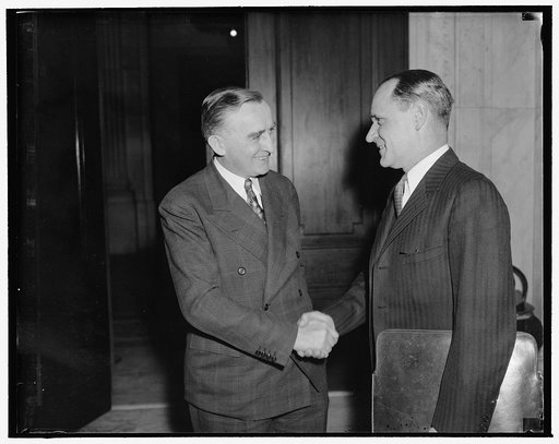 Scheduled to tell Monopoly Committee of iron firm's financing. Washington, D.C., Dec. 14. B.A. Tomkins on the Bankers Trust Co. of New York City, photographed with Sen. Joseph O'Mahoney, Chairman of the Monopoly Committee, is scheduled to tell the committee sometime today of the financing of the Cle