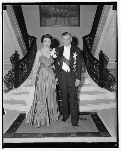 Czech Minister and wife leave for White House diplomatic reception. Washington, D.C., Dec. 14. Still recognized as the Minister from Czechoslovakia to the United States, Vladimir Hurban with his pretty wife made a gallant pair as they left the Legation for the Diplomatic reception at the White House